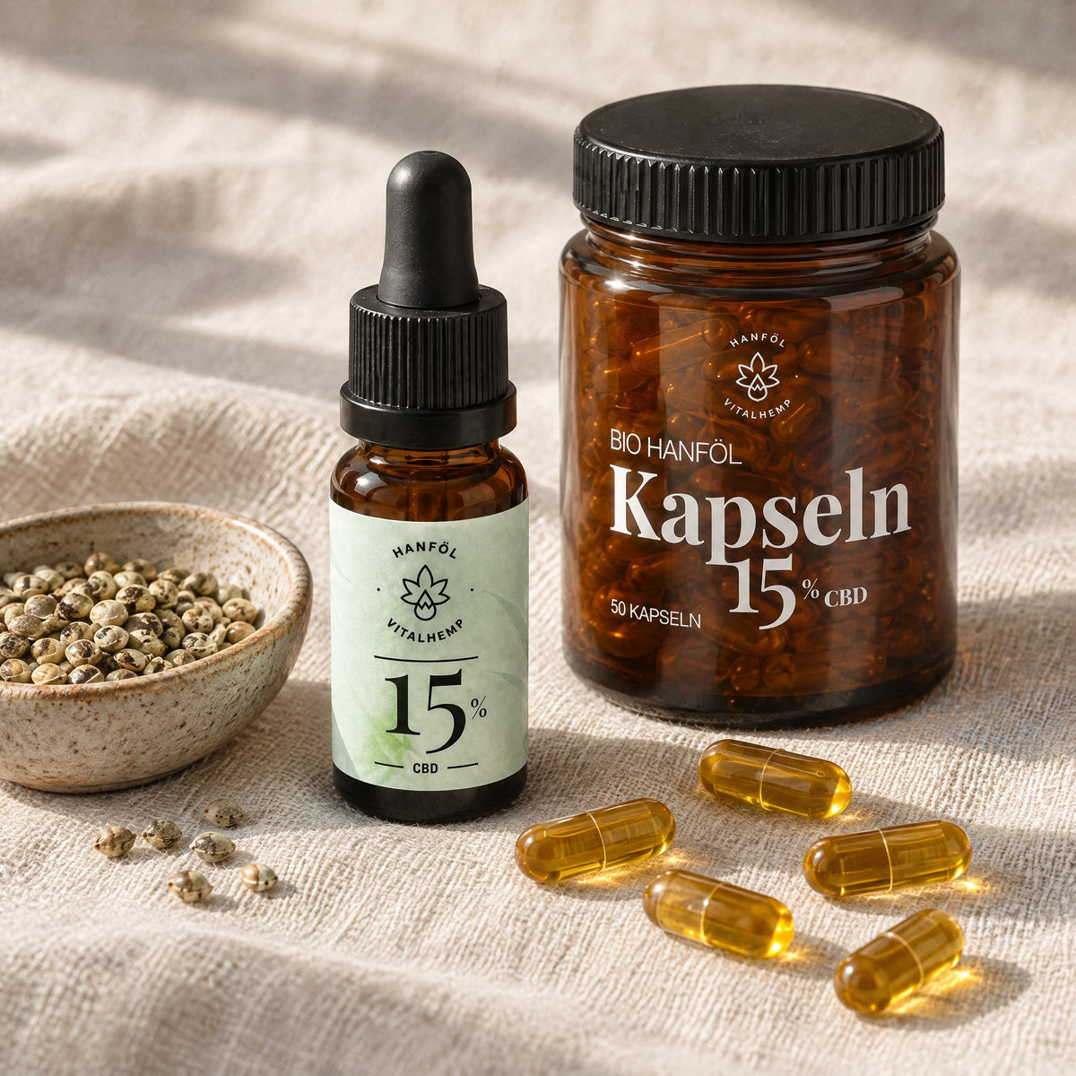 CBD-Öl 15 % neben Hanfsamen und Dose CBD-Kapseln 15 % mit einzelnen Kapseln auf Leinen